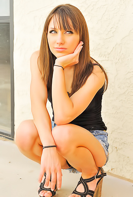 Risi in a skirt and heels flashing outdoors